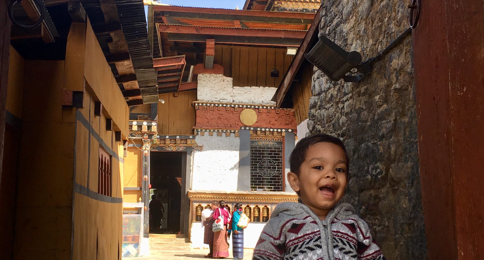 The 2 year old sitting on the steps of a 12th century monastery, Changangkha Lakhang, Thimphu, Bhutan. Samai Haider