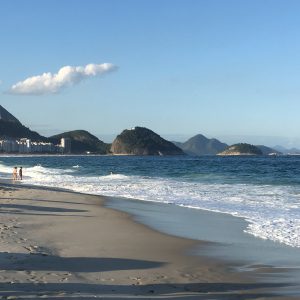 A hawker traipses down Copacabana beach, Rio de Janeiro, Brazil