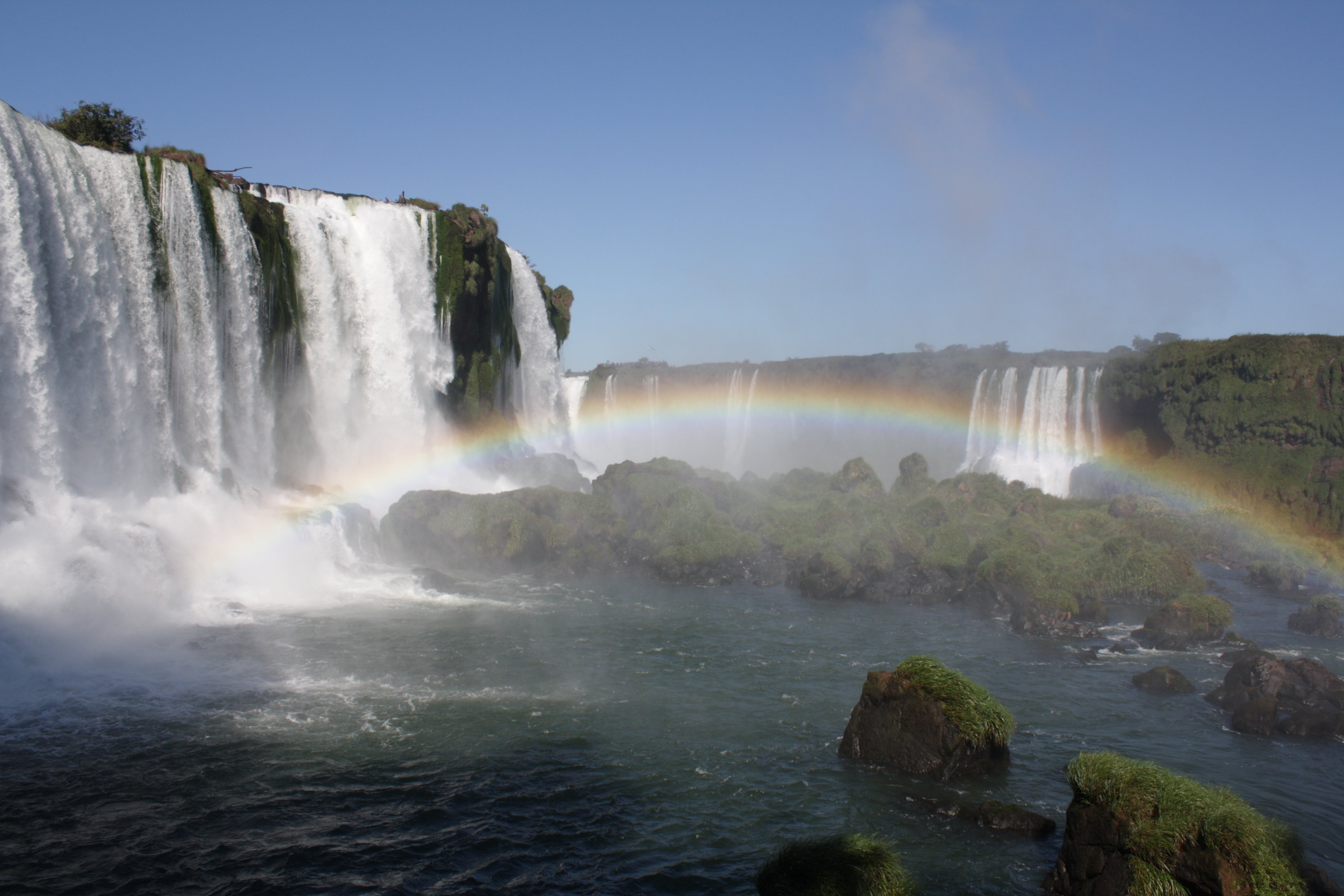 A rainbow arcs over the foamy river, Iguazu Falls, Foz do Iguacu, Brazil
