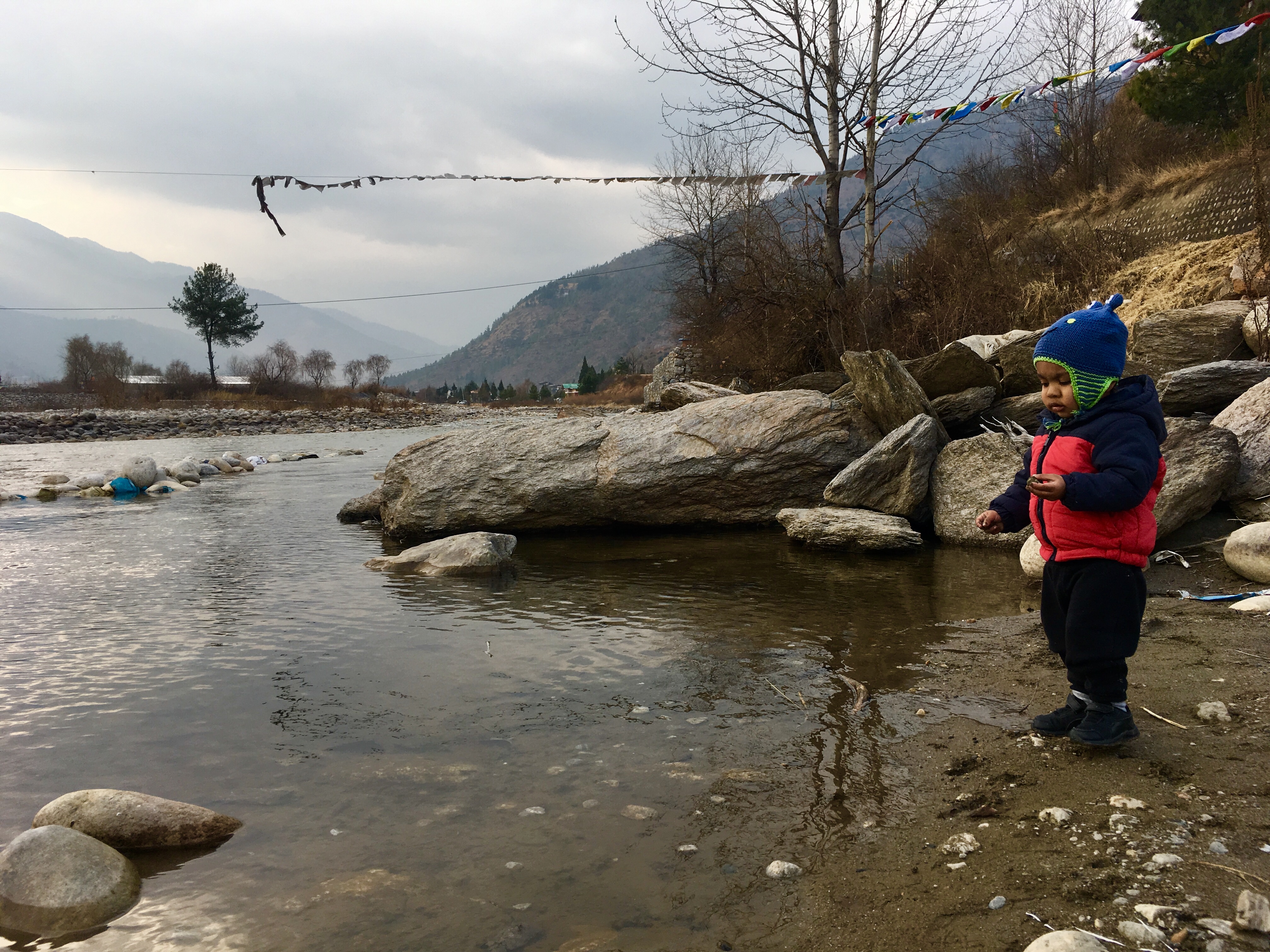 Throwing rocks into the Paro River, Bhutan