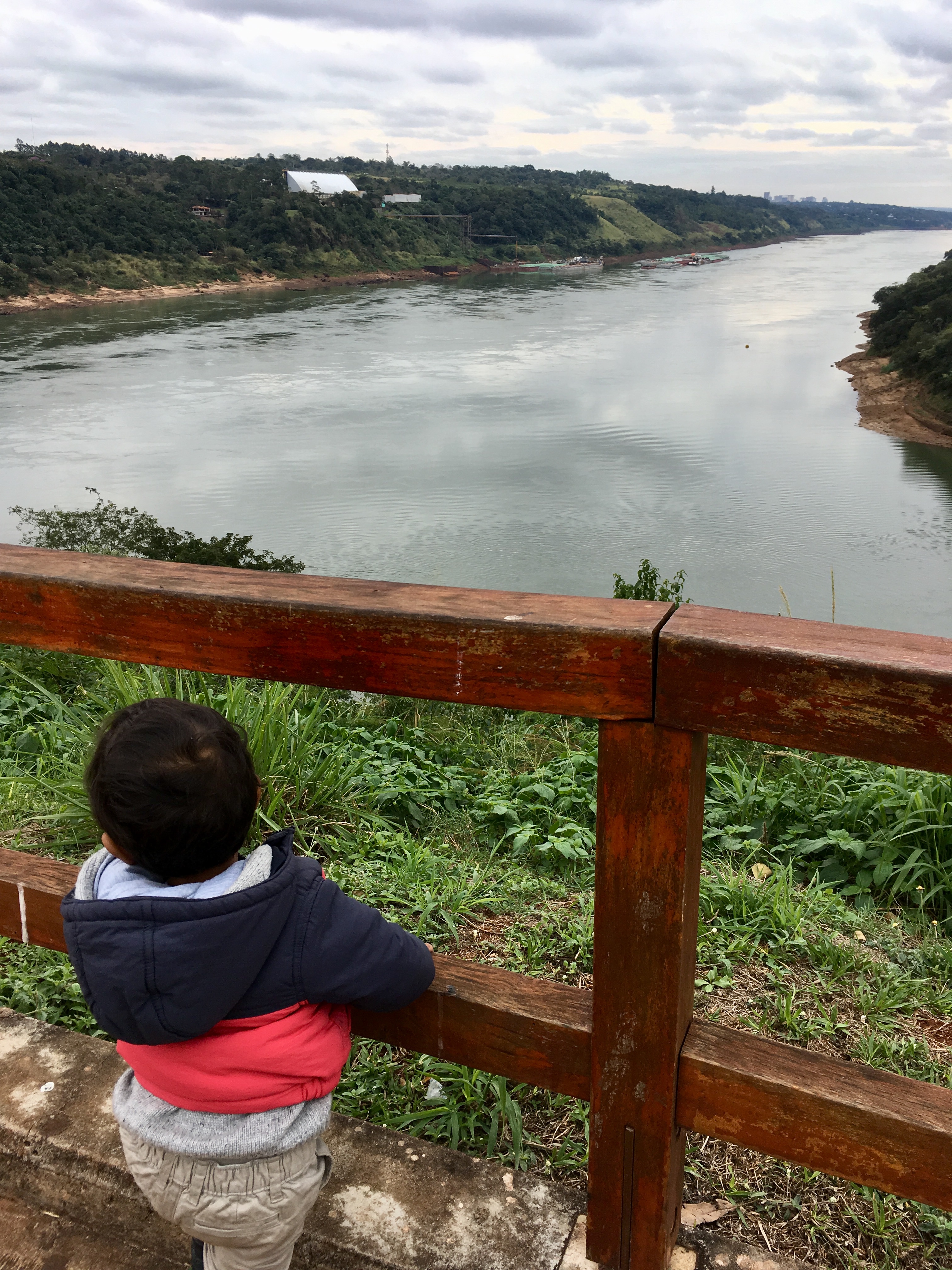 My toddler looking out over Brazil and Paraguay from the Three Frontiers, Argentina
